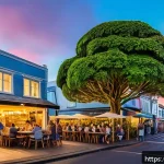 뉴질랜드 주요 도시 비교  오클랜드 vs 웰링턴 vs 크라이스트처치 - A vibrant urban street scene in Auckland&rsquo;s Ponsonby neighborhood during golden hour, showcasing a co...